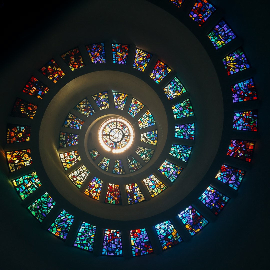 A spiralling stained glass window inside a chapel at Thanks-Giving Square in Dallas.