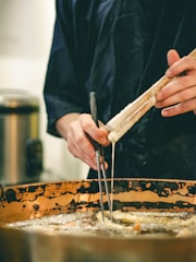 Technician servicing a commercial kitchen's deep fryer equipment.