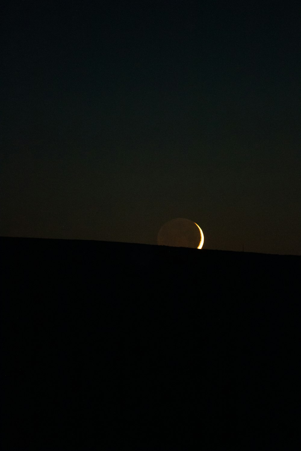 the moon is setting over the horizon of the horizon