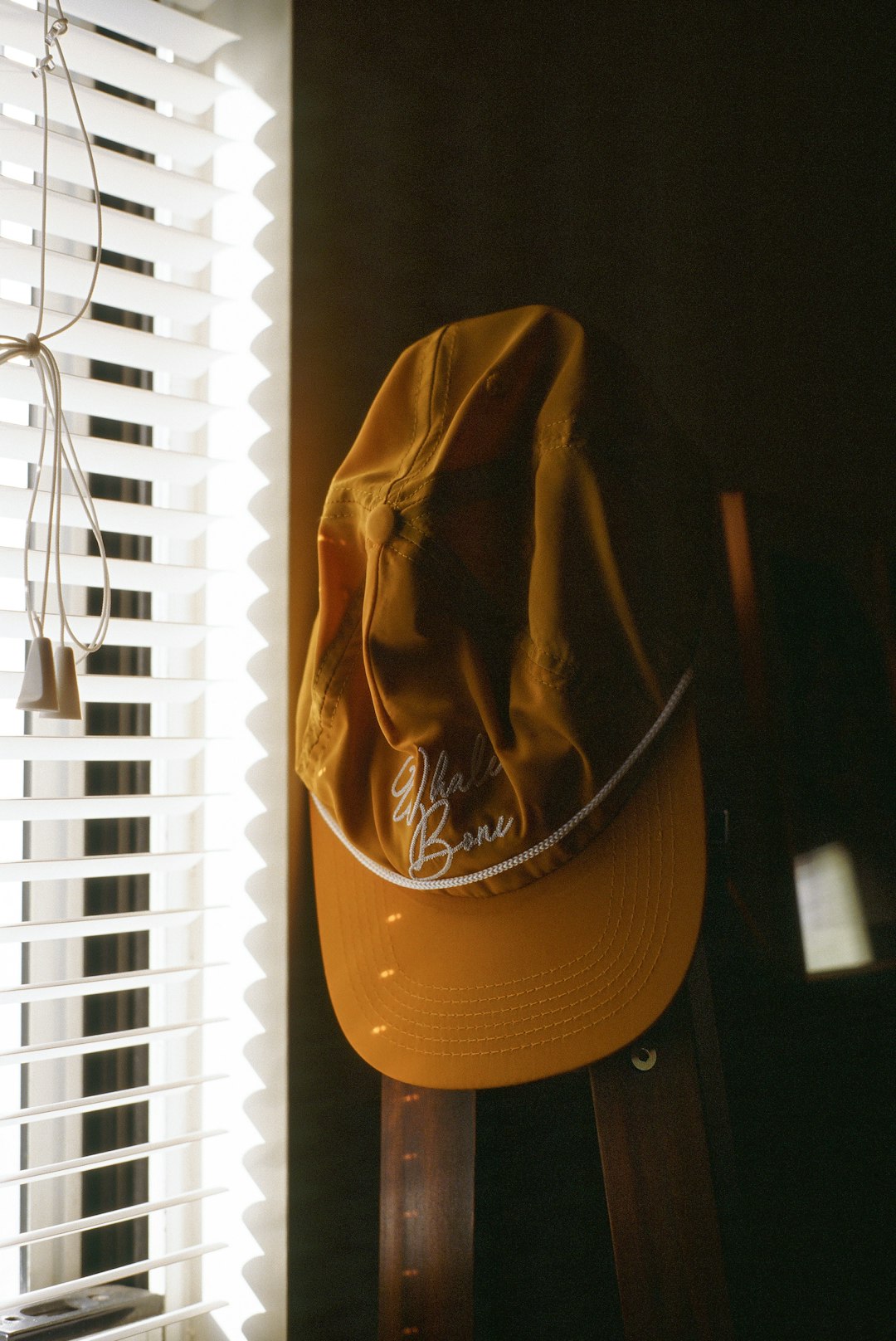 orange cap on rack near window