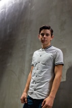 A lifestyle shot showing a person wearing a printed shirt against a warm, neutral background.