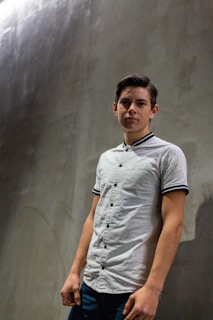 Model wearing the t-shirt casually paired with light jeans, standing against a soft, neutral backdrop.