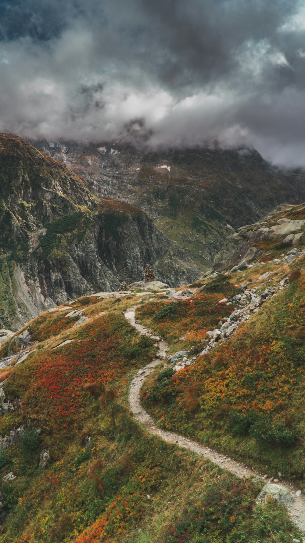 dirt road and grass mountains during day