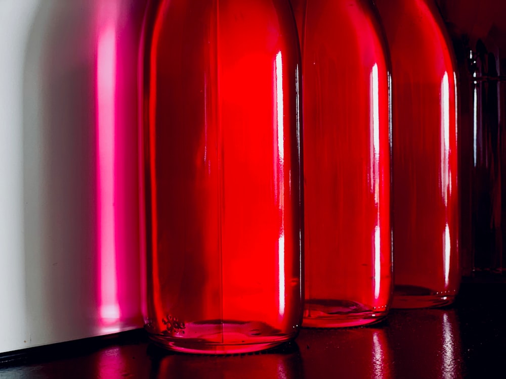 three red glass bottles