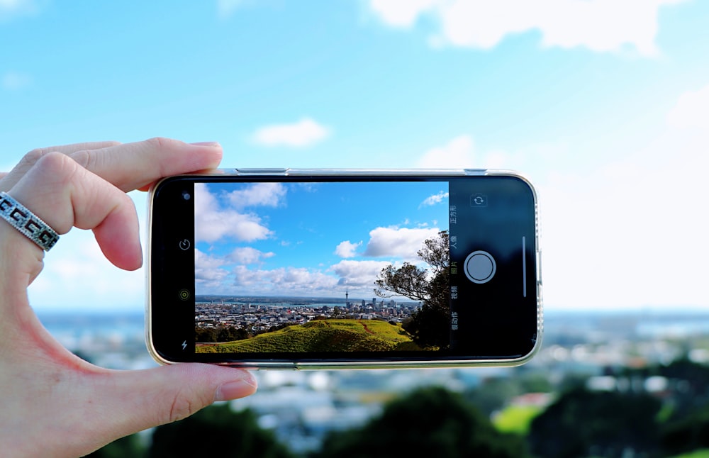 person using smartphone while taking picture