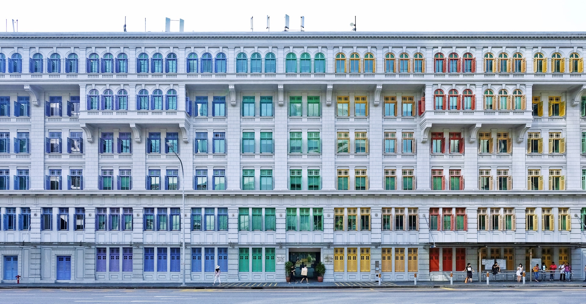 people walking near multicolored building during daytime