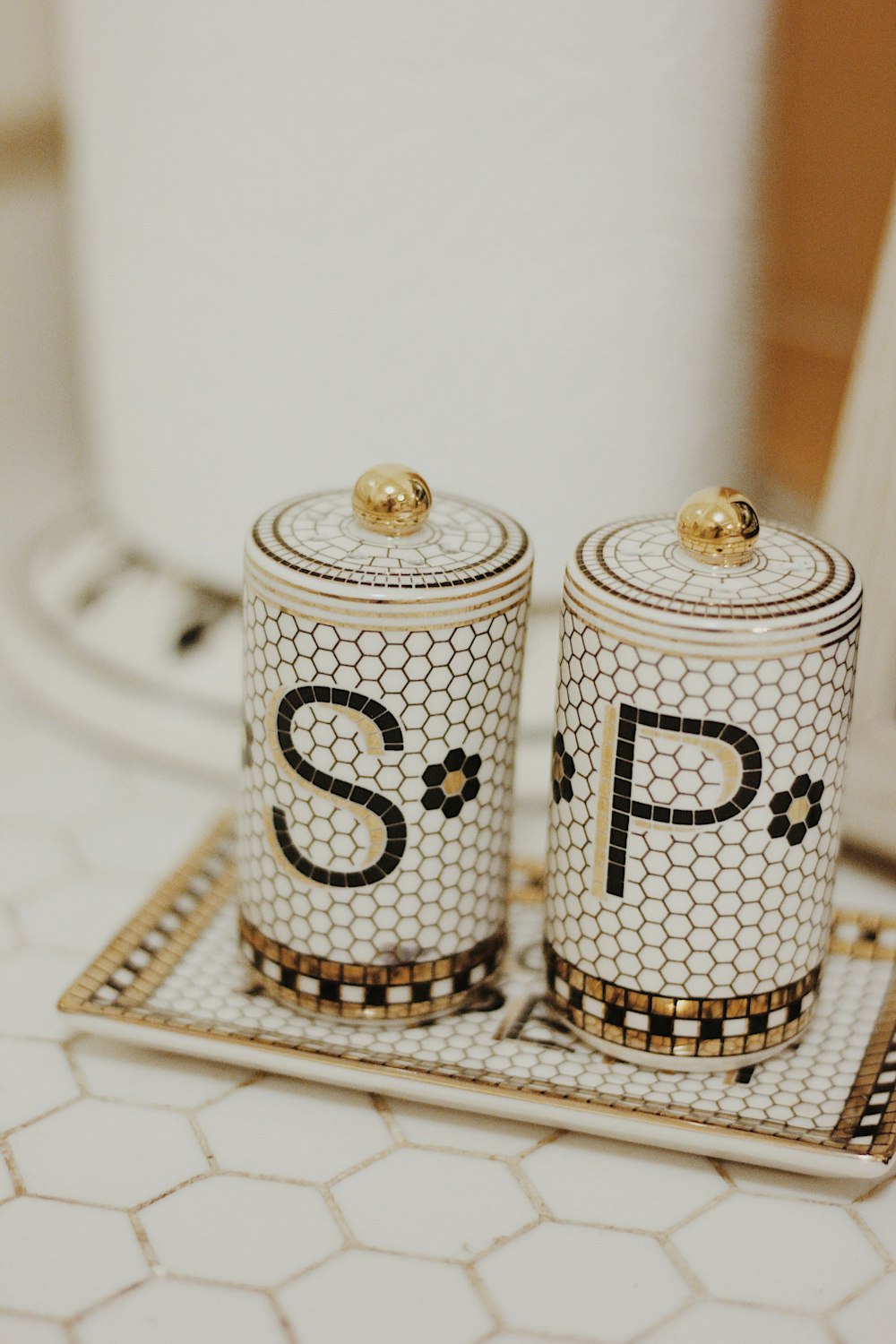 white-and-black SP bottles on gray tray