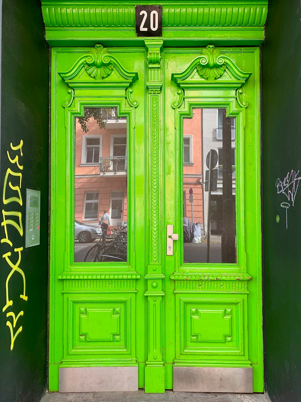 green wooden glass door
