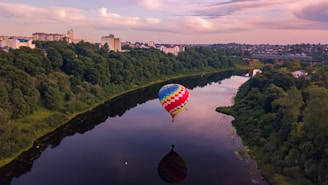 red, yellow, and blue hot-air balloon on top of lake