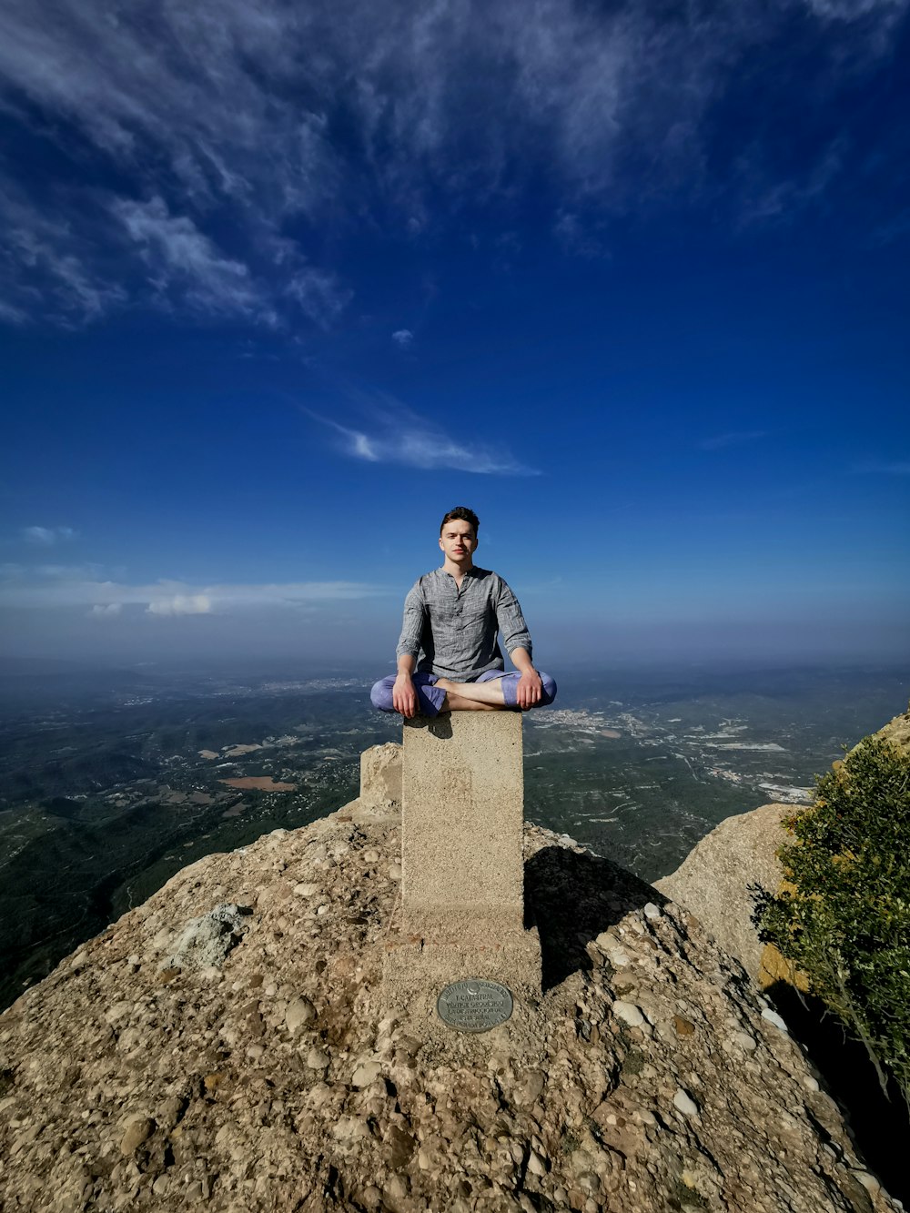 man sitting on column