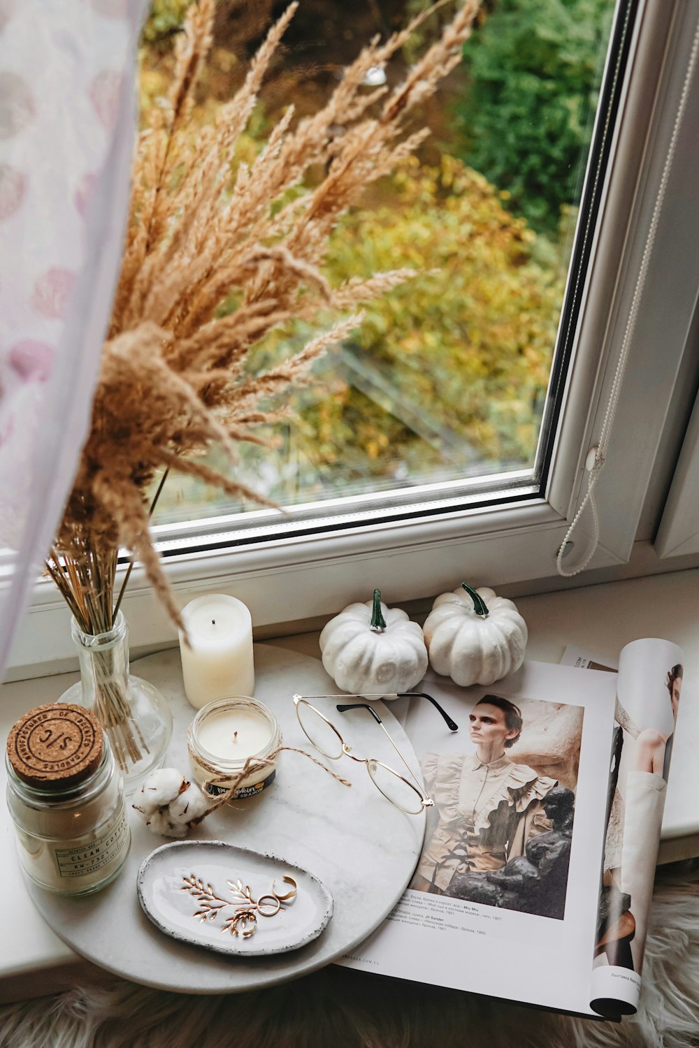 candles and squash near closed glass window