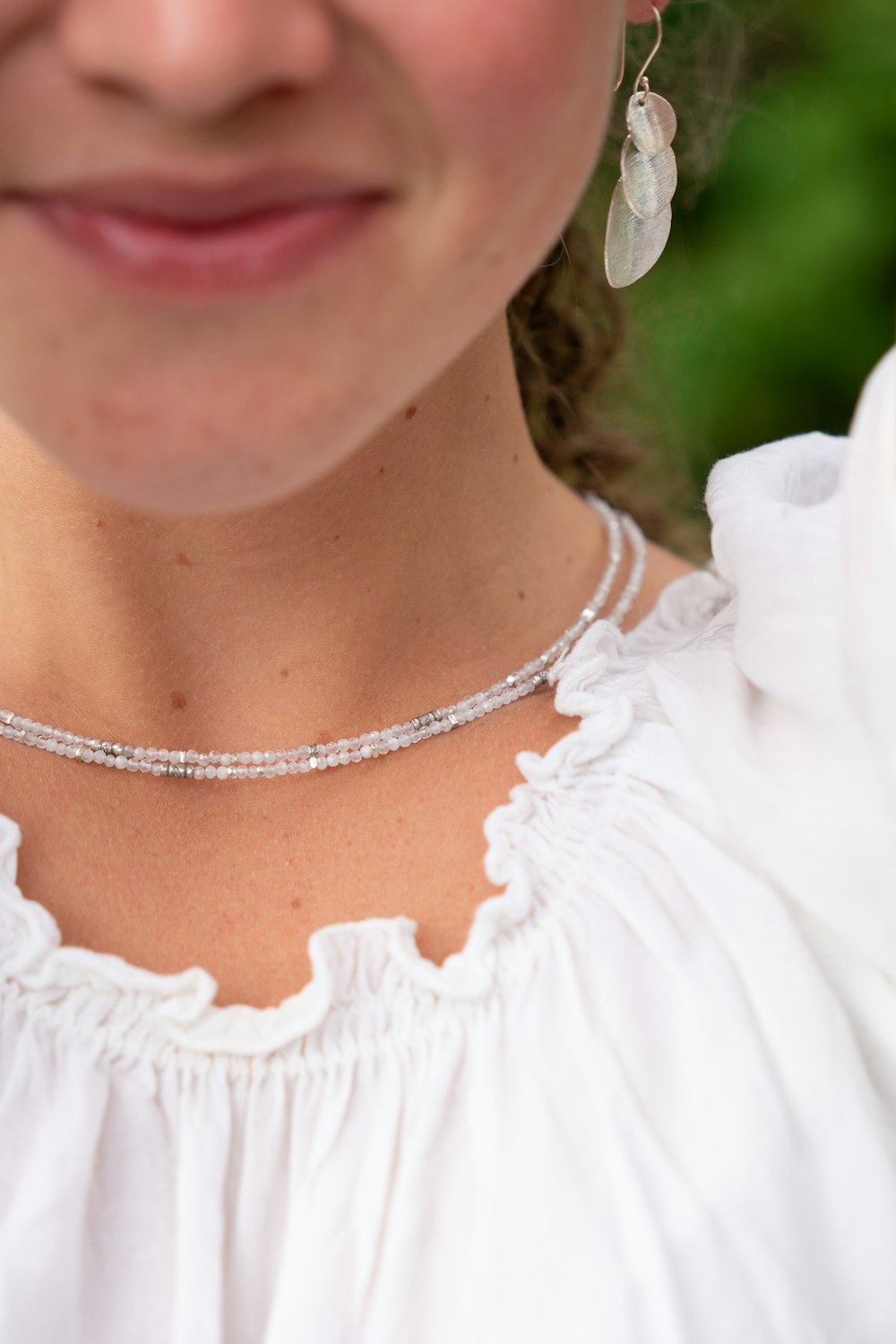 smiling woman in white top