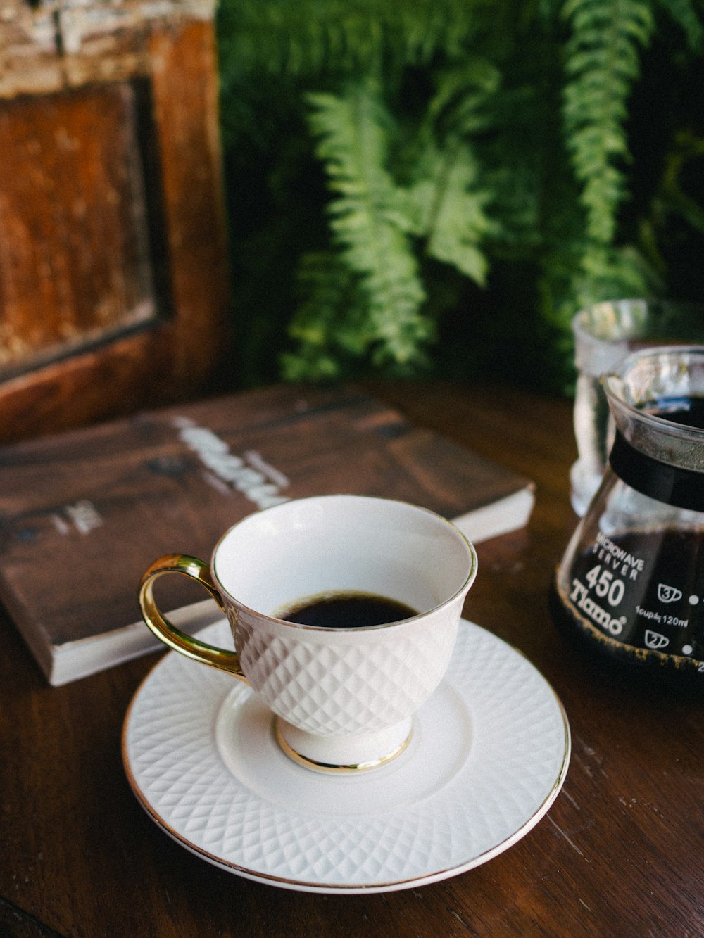 shallow focus photo of white ceramic mug