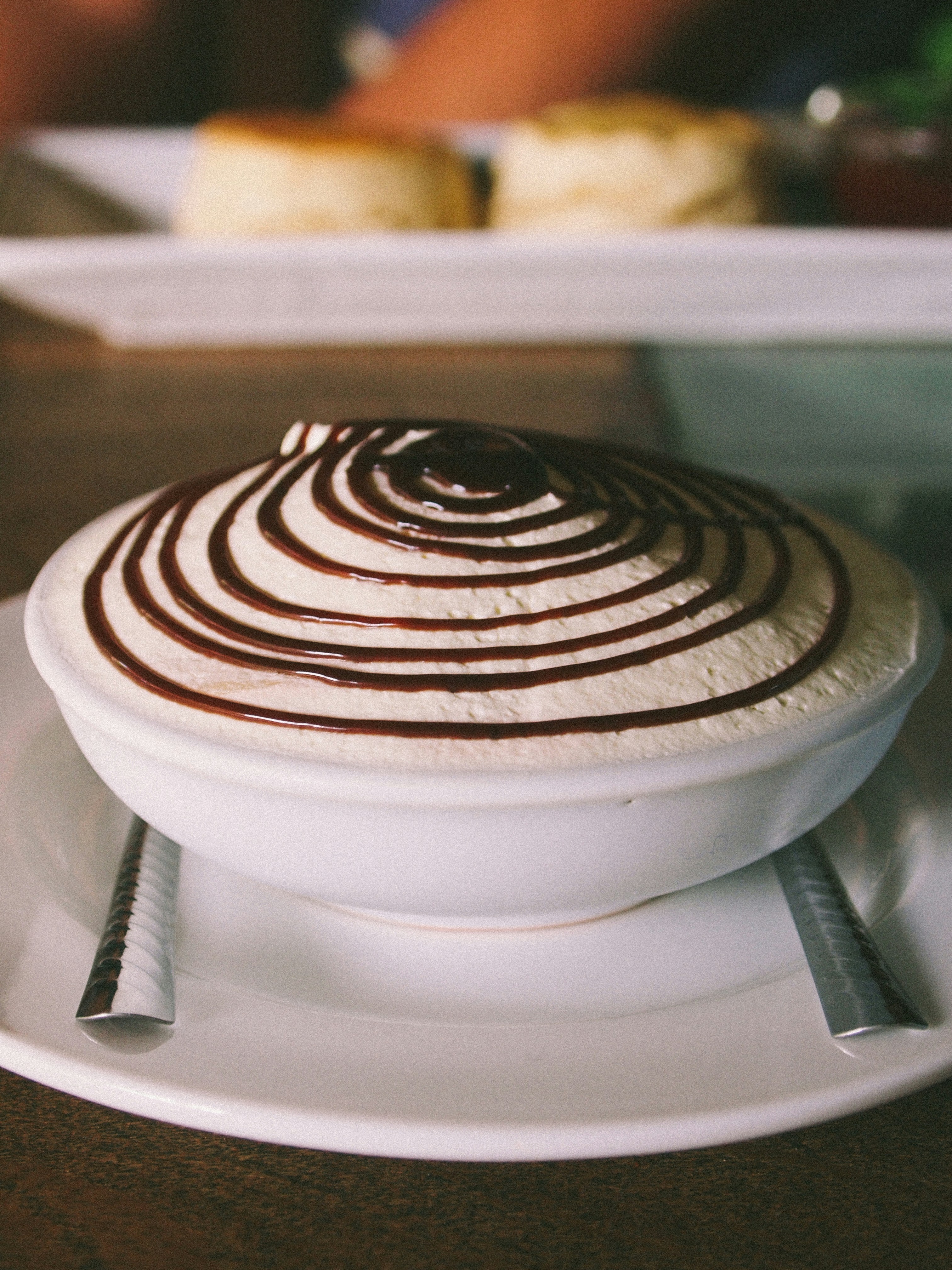 a white plate topped with a dessert on top of a wooden table