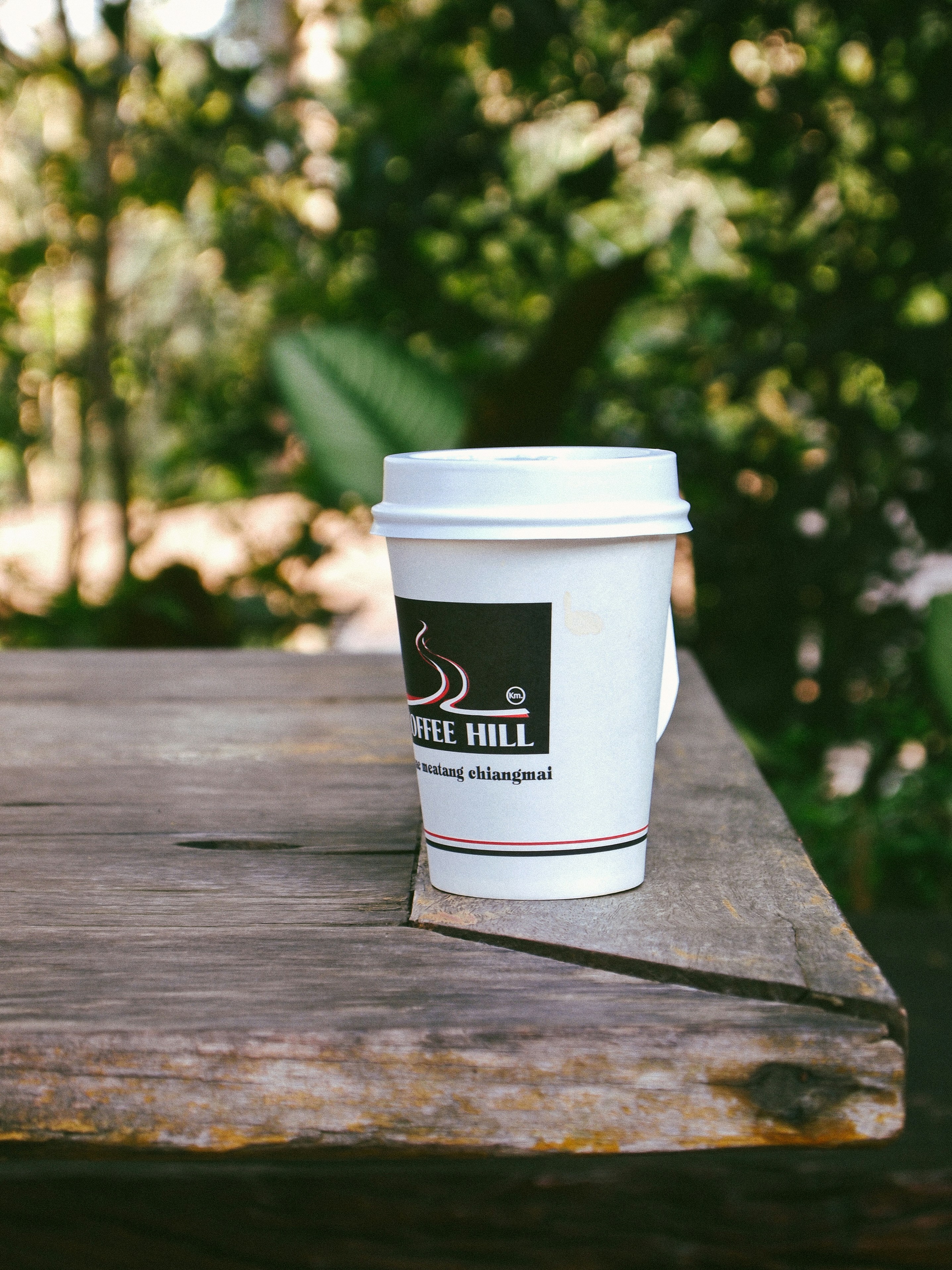 white plastic tumbler on brown wooden surface