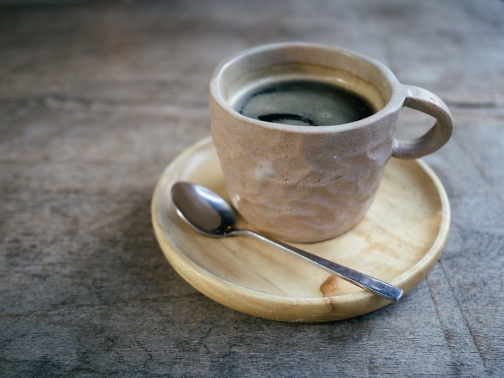 grey and white ceramic teacup with coffee