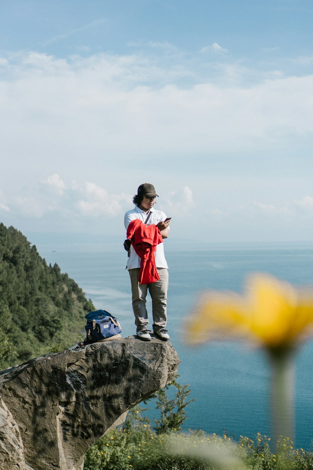 woman wearing grey pants standing near shore