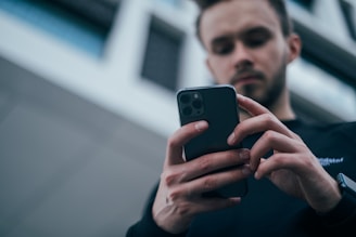 A focused learner using a smartphone to practice DMV permit questions on a clean, user-friendly app interface.