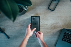 person holding black iPhone 11 box