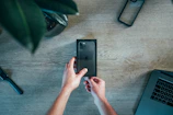 Hands unboxing a new high-tech device with excitement and care.