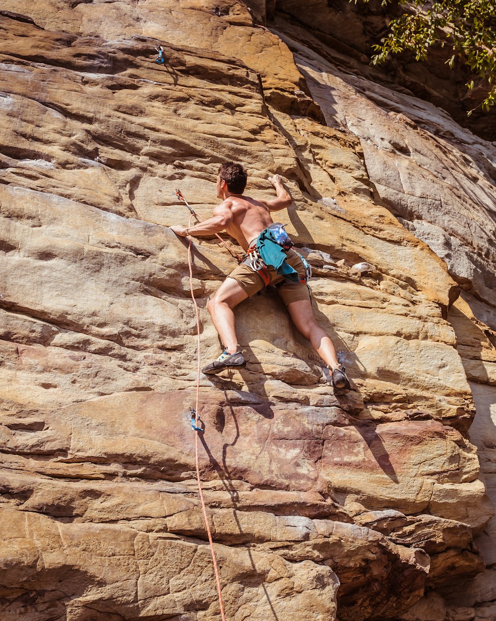 man climbing on rocky mountain