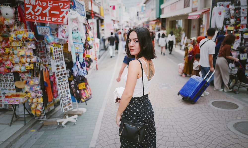 woman standing near stores during daytime