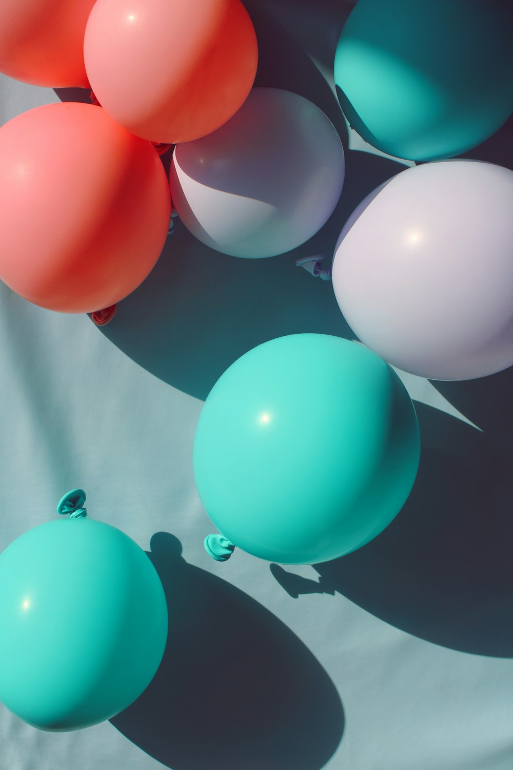 teal, white, and pink balloon