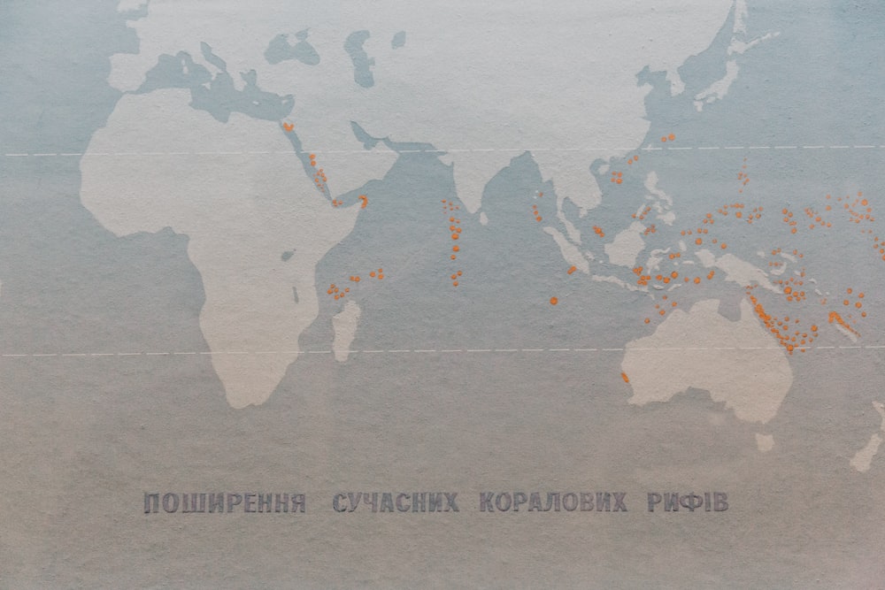 a map of the world with orange dots