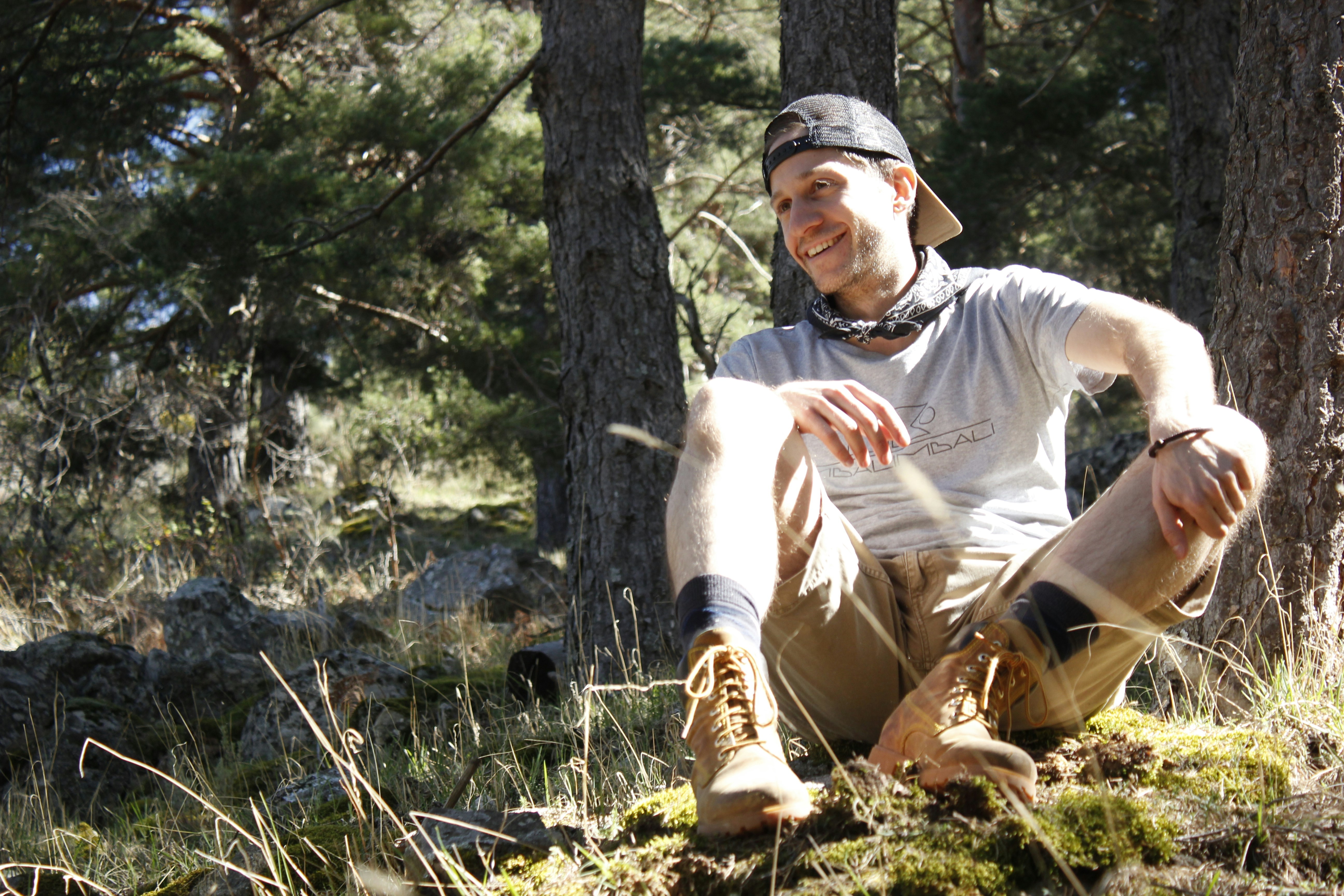 sitting man wearing gray crew-neck t-shirt during daytime