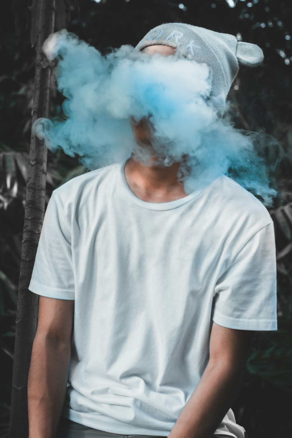 man realising smoke from his mouth