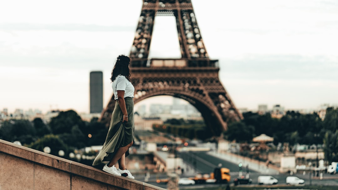 selective focus photography of woman standing in front of Eiffel Tower, Paris