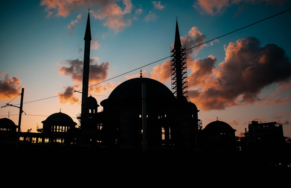 silhouette photography of buildings under clear blue sky