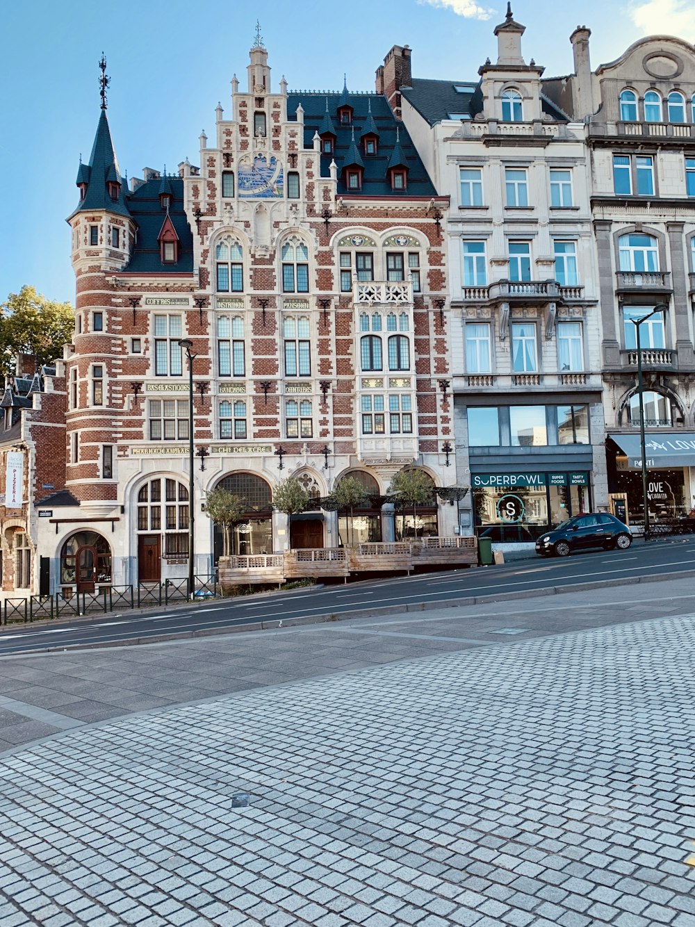 vehicle beside buildings during daytime