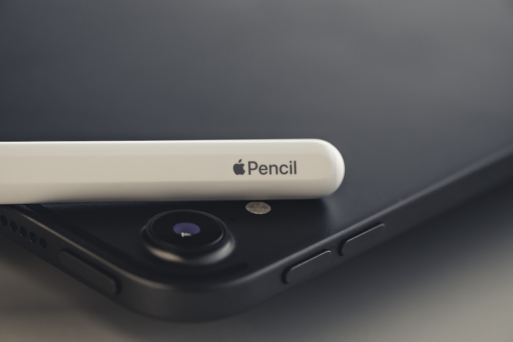 black iPad and Apple Pencil