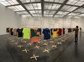 Colorful display of classic football jerseys hanging in a museum-like setting