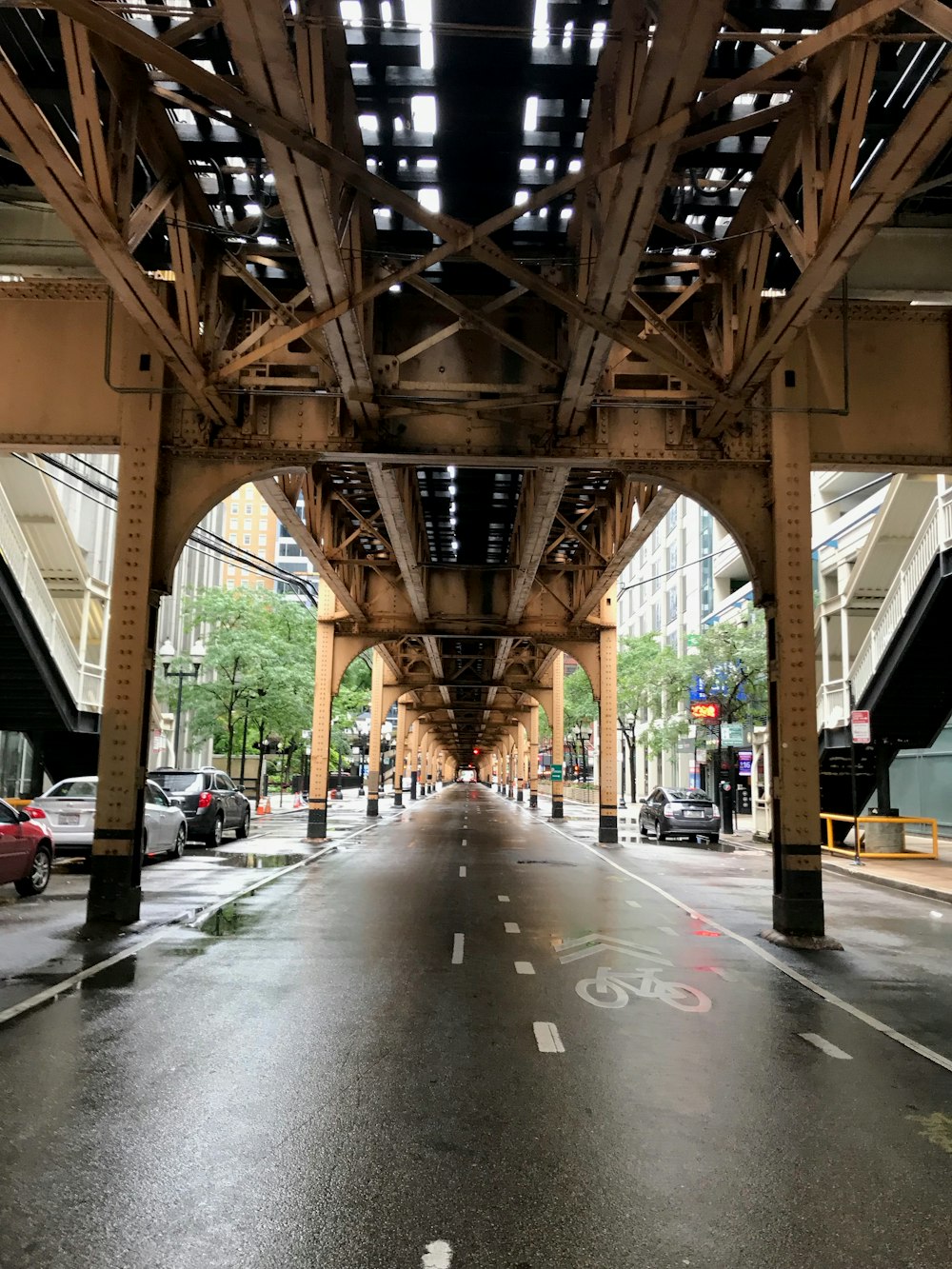 different vehicles on road viewing bridge during daytime