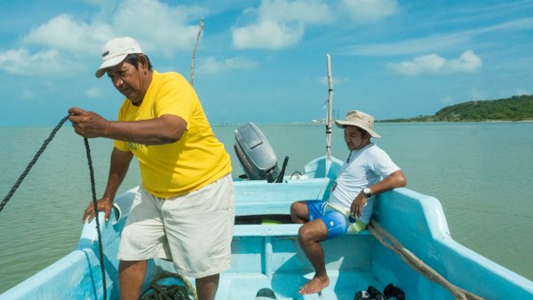 Men riding on boat — Campeche, Mexico