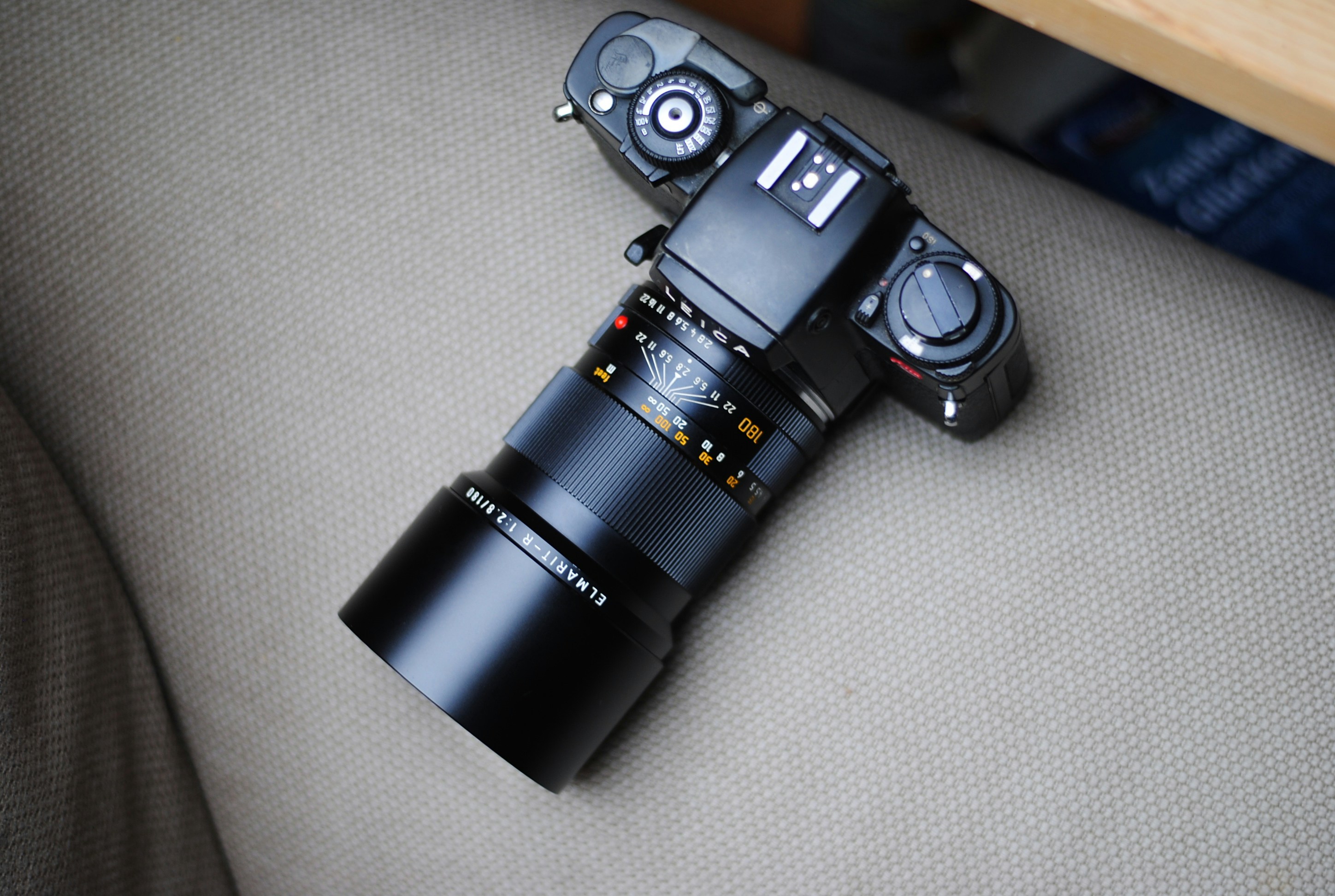 black DSLR camera on white textile