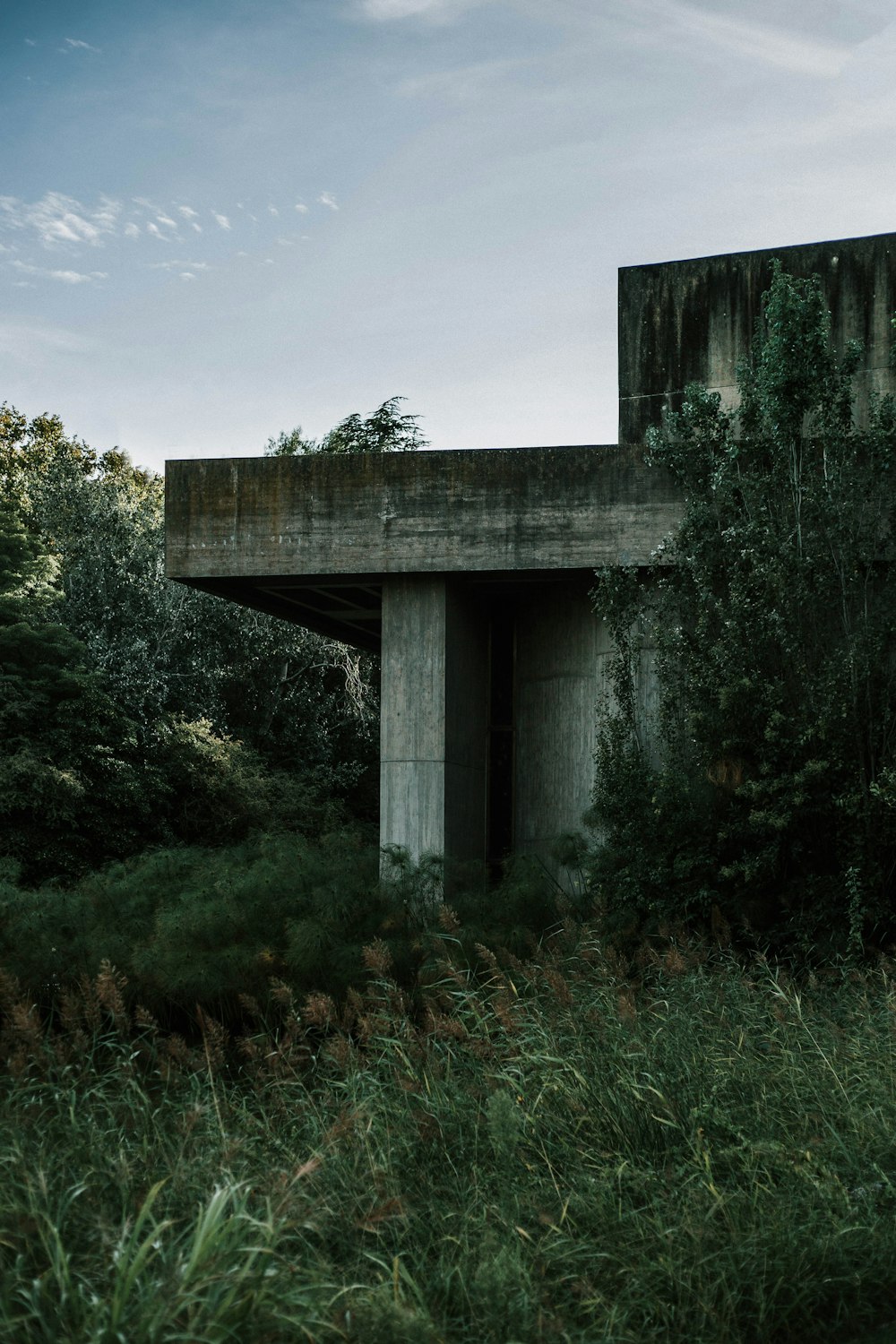 gray concrete house beside trees during daytime