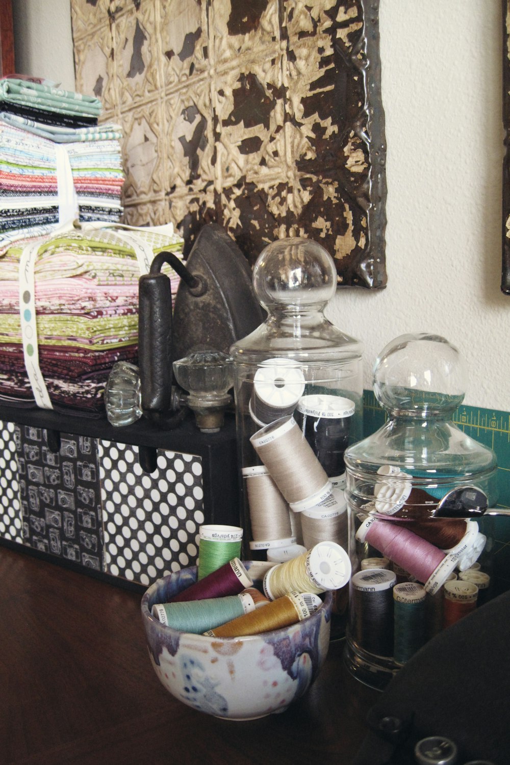 a wooden table topped with lots of craft supplies