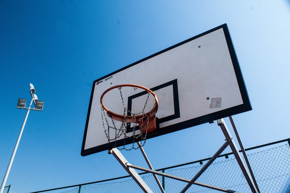 white and black metal outdoor basketball hoop during daytime