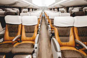 Interior view of a clean, modern Tuấn Em bus with comfortable seating and natural light.