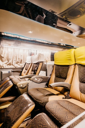 Interior view of a sleek party bus with ambient LED lighting and plush leather seats.
