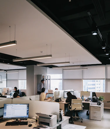 Modern office workspace with accountants collaborating over financial documents.