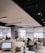 A clean, modern office workspace with sunlight illuminating polished surfaces and organized desks.