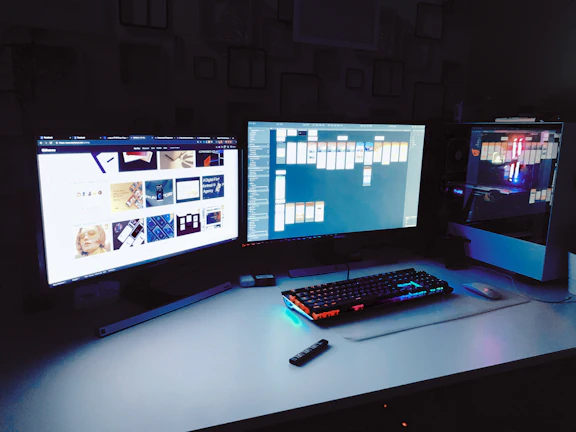 A sleek ultrawide setup with ambient purple neon lighting and multiple productivity apps open.