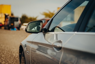 Side mirrors reflecting a busy warehouse where parts are carefully inspected and packed.