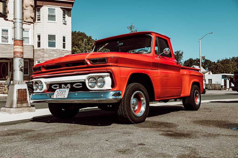 classic red GMC single cab pick up truck on road