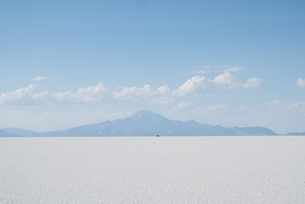 body of water under cloudy sky