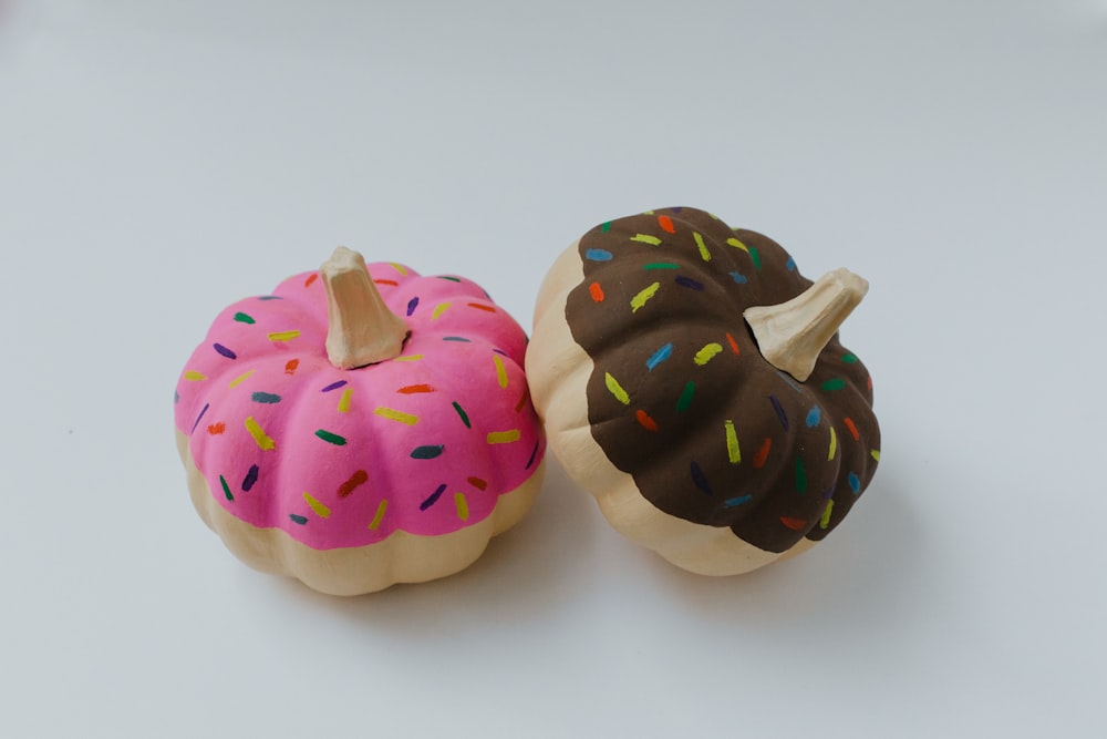 two strawberry and chocolate pumpkin doughnut toy